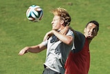 Ben Halloran fights for the ball with Jason Davidson at Socceroos training in Vitoria.