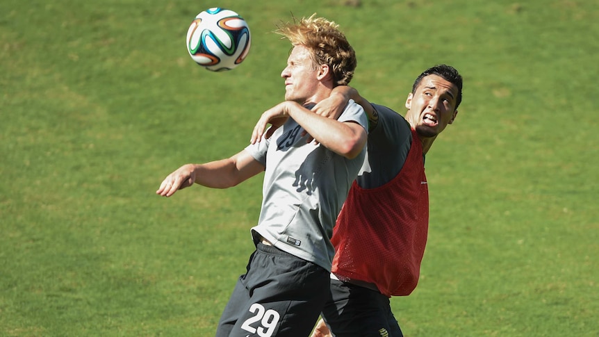 Ben Halloran fights for the ball with Jason Davidson at Socceroos training in Vitoria.