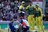 Mitchell Starc looks on as Eoin Morgan is treated for a blow to the head