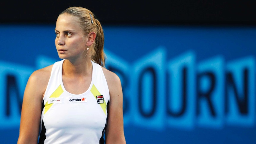 Jelena Dokic looks off to the side with a blank expression during a women's singles match.