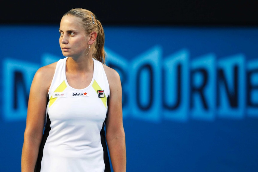 Jelena Dokic looks off to the side with a blank expression during a women's singles match.