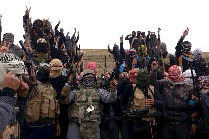 Gunmen gesture during fighting in Ramadi.