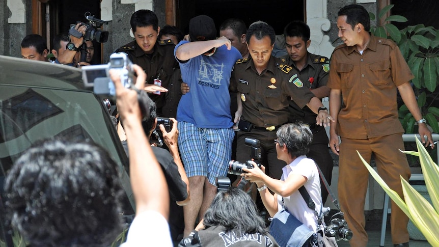 A 14-year-old Australian boy, arrested for alleged cannabis possession in Bali, leaves the District Prosecutor's office