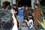 A 14-year-old Australian boy, arrested for alleged cannabis possession in Bali, leaves the District Prosecutor's office