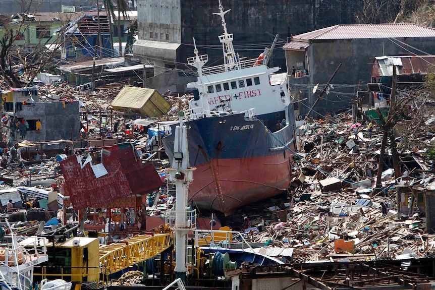 A cargo ship washed ashore by Typhoon Haiyan sits among the ruins of Tacloban.
