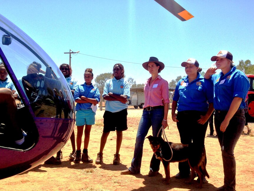 Kids and Rebecca Freshwater standing around a helicopter.