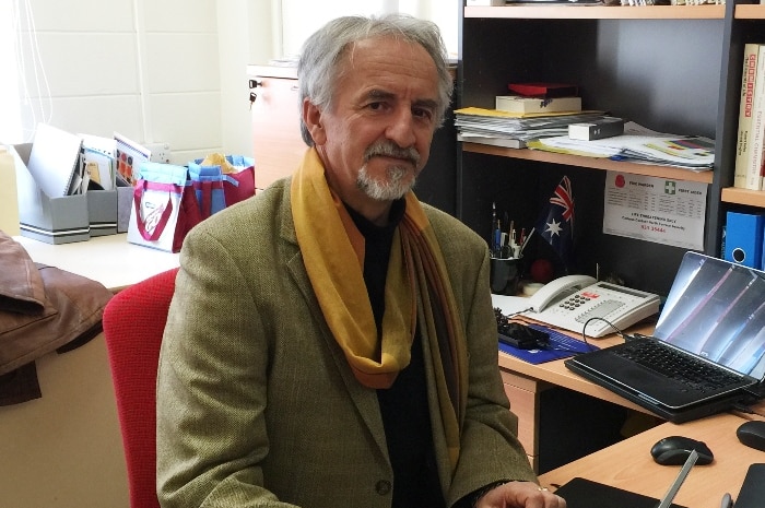 Professor Dosic sits at his desk