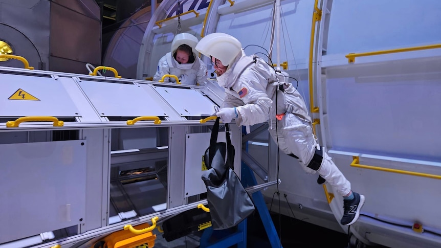 two students from loreto college ballarat wearing astronaut suits and participating in a space mission simulation 