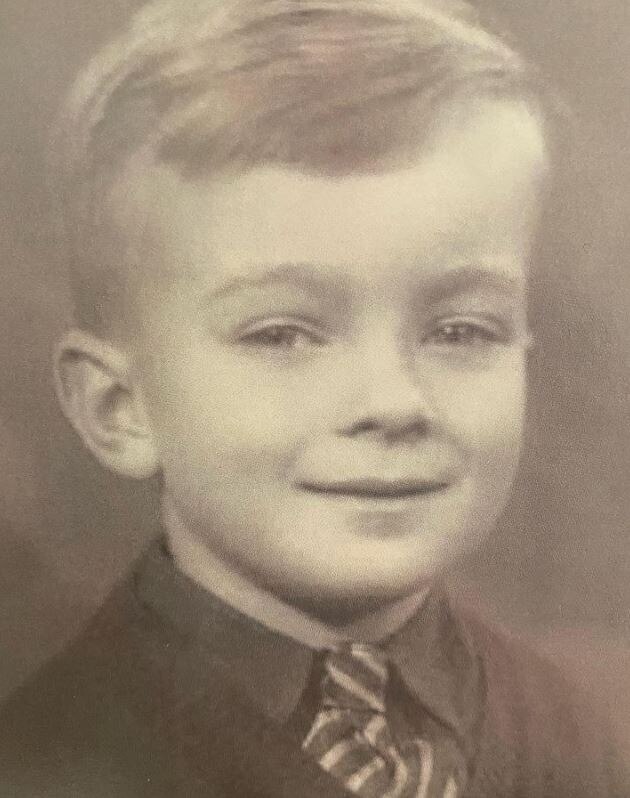 a young boy looking and smiling