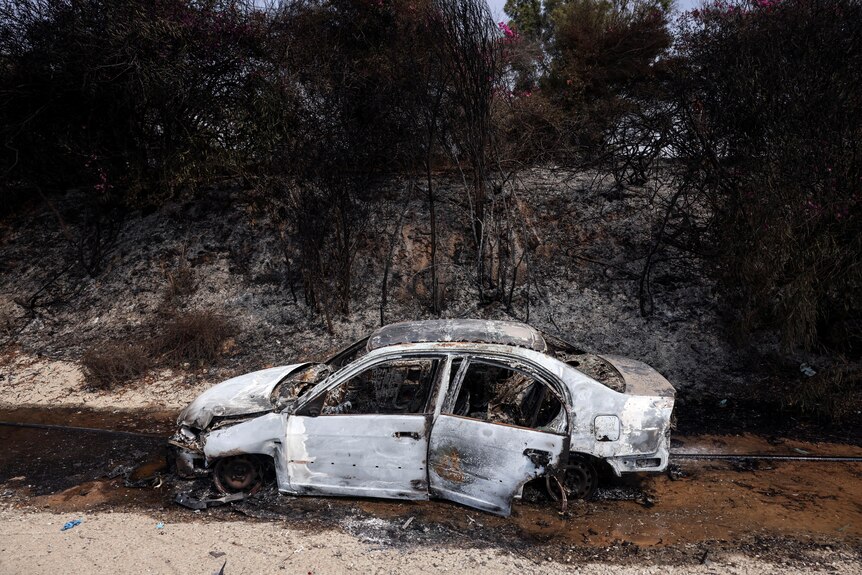 Burnt out car on road 