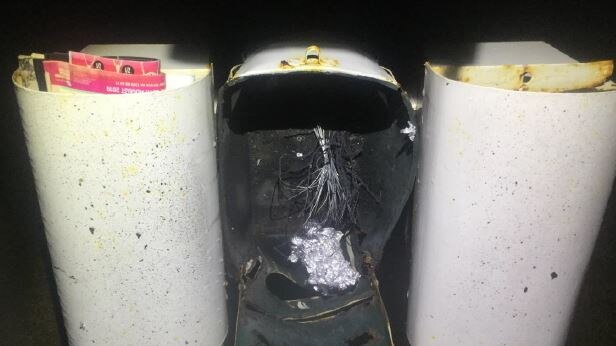 A letterbox is extensively damaged by an explosive device.