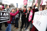 Anti-abortion marchers (L) argue with pro-abortion rights activists (R) in front of the US Supreme Court.
