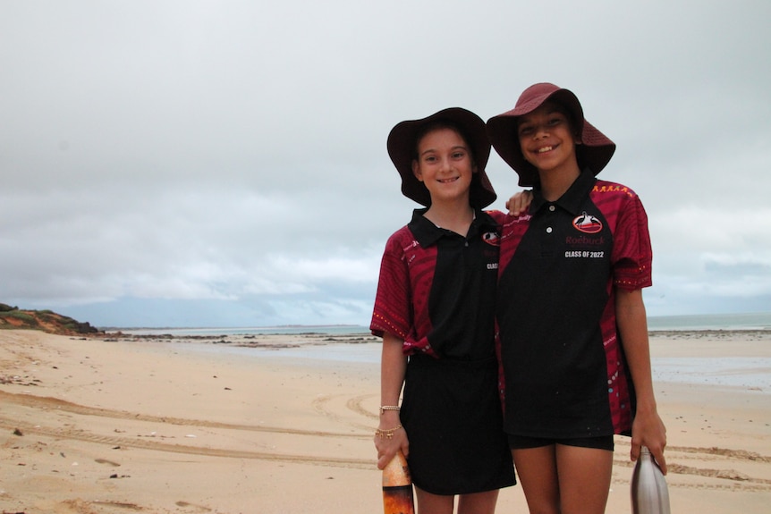 Students stand on Cable Beach