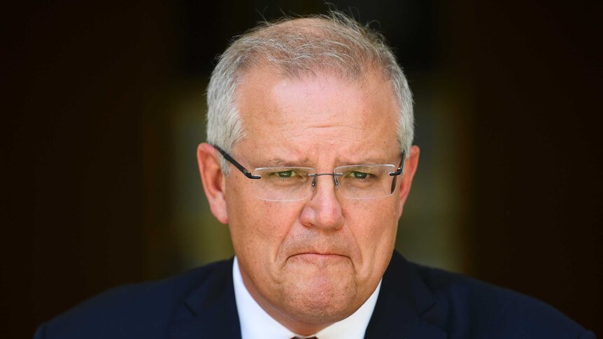 Morrison purses his lips during a press conference