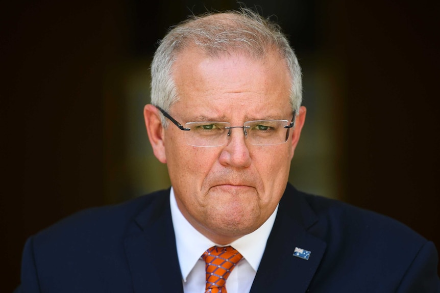 Morrison purses his lips during a press conference
