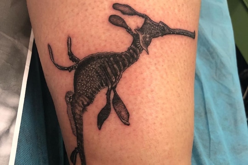 Tattoo of a sea dragon done with black ink. 