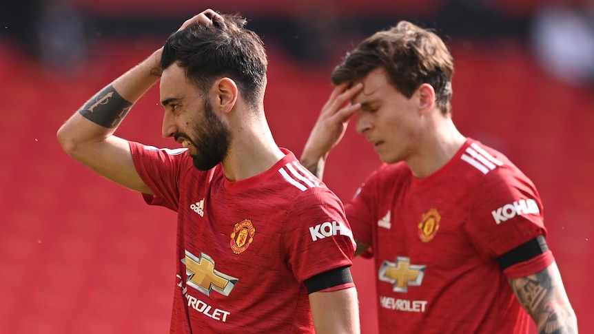 Two Manchester United players react during an English Premier League match.