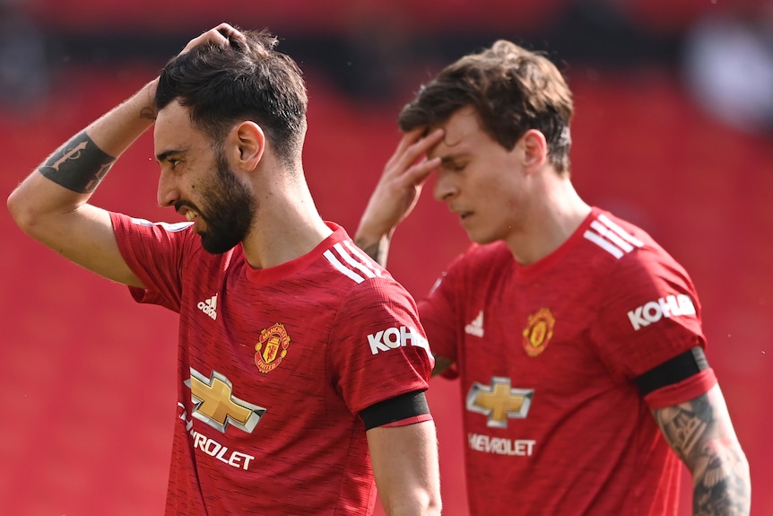 Two Manchester United players react during an English Premier League match.