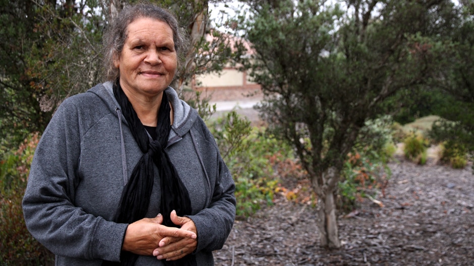 A woman stands in the bush