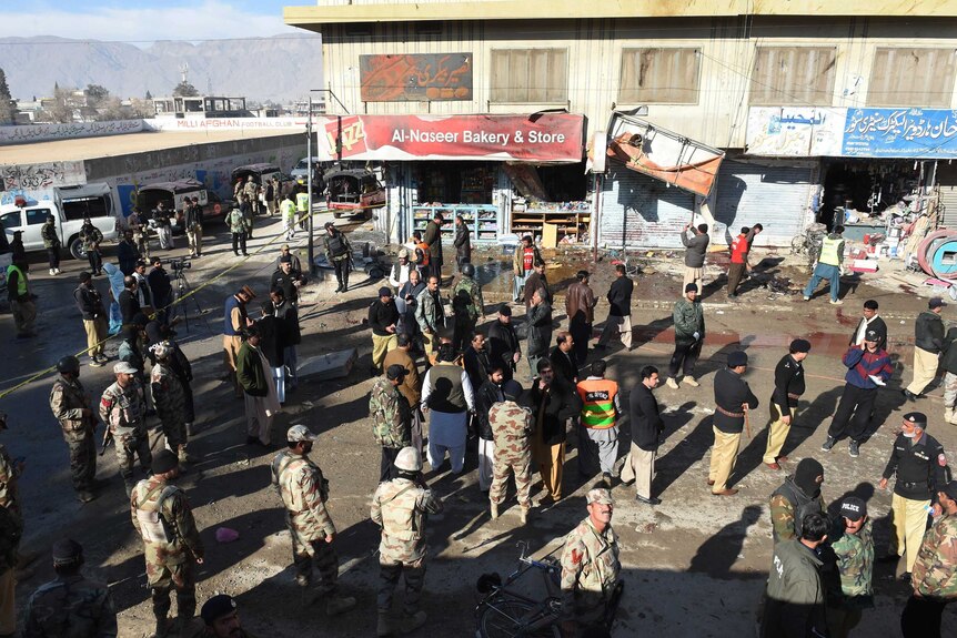 Pakistani police examine the site of a bomb blast in Quetta