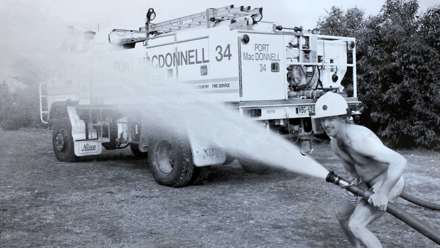 Port Macdonnell footballer Grant Fensom poses with a fire truck