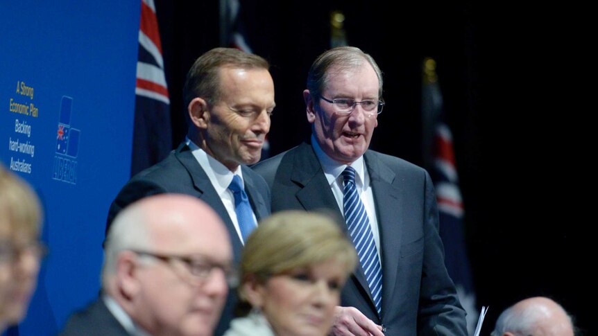 Prime Minister Tony Abbott (left) speaks with federal director of the Liberal Party Brian Loughnane during the party's 2015 Federal Council meeting