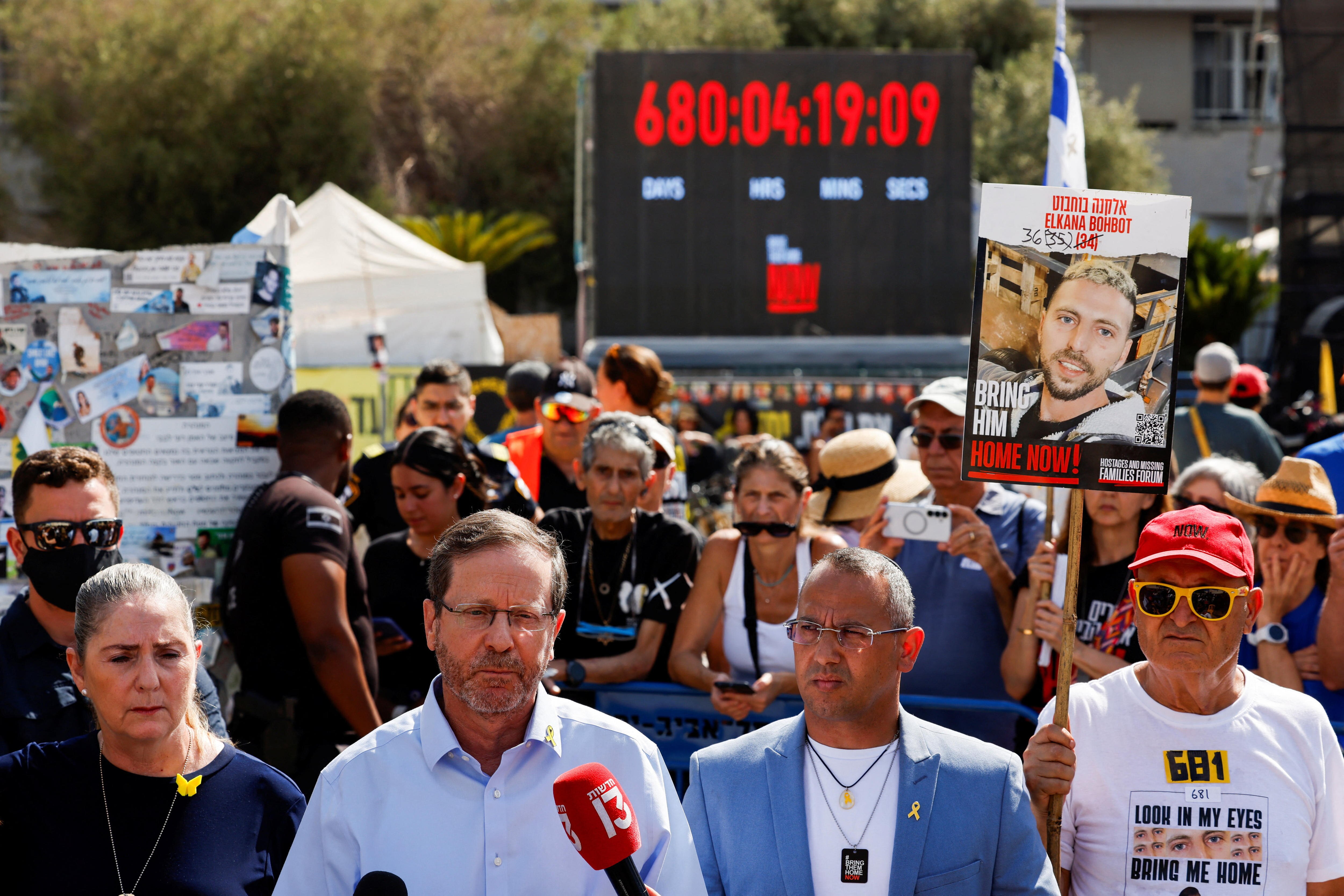 Isaac Herzog standing in front of a crowd of people, shoulder to shoulder with other people