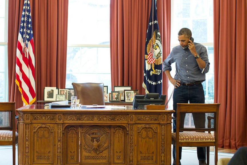 Barack Obama speaks on the phone at the White House