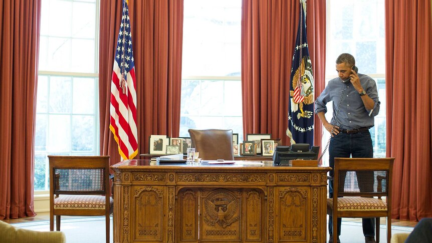 Barack Obama speaks on the phone at the White House