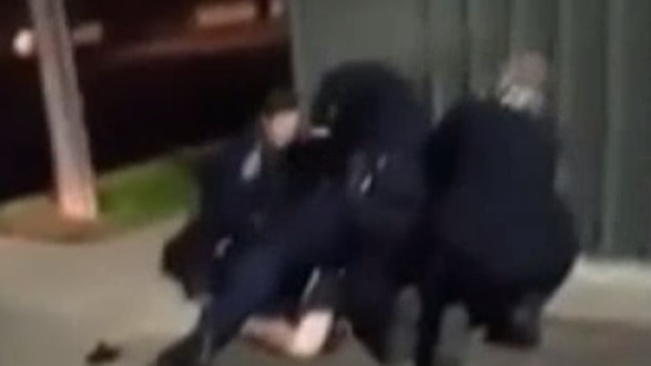 Still from footage showing an SA Police officer appearing to strike a man in custody in Adelaide's north.