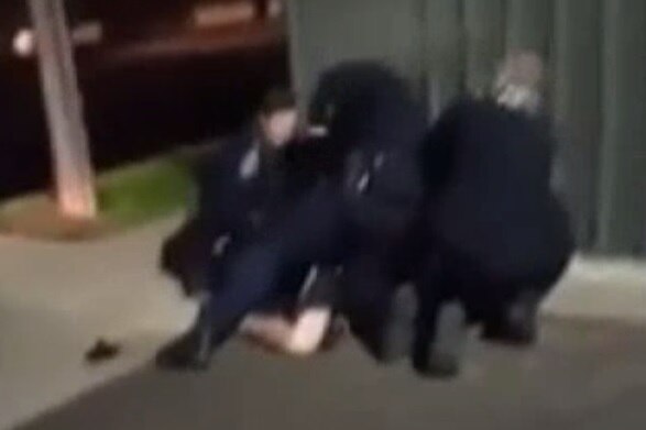 Footage shows an SA Police officer appearing to strike a man in custody in Adelaide's north.