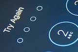 Close up of the lock screen on an iPhone with a message saying Try Again.