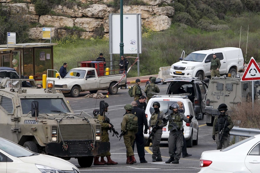 Israeli security forces gathered near the scene of the attacks.