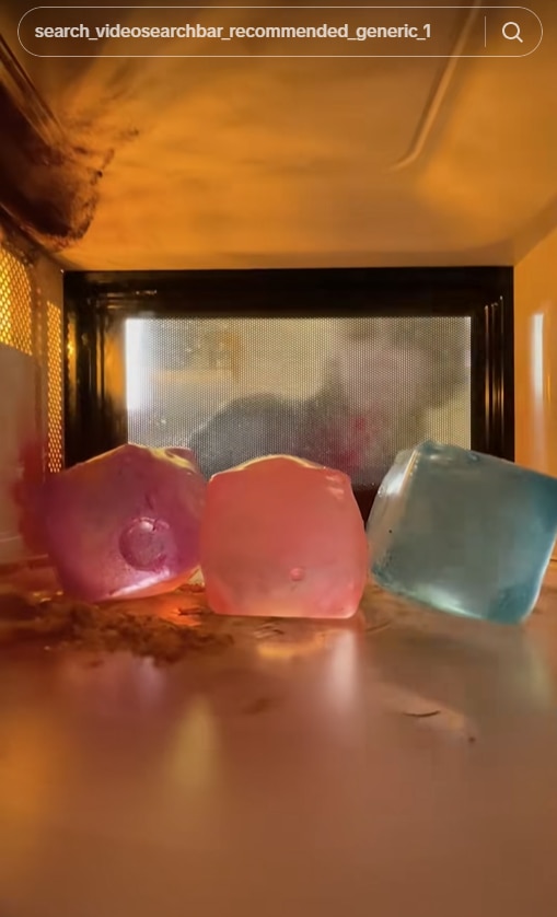 Three squishy cubes inside a microwave.