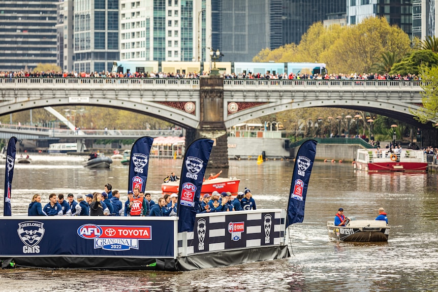 A barge on the Yarra River containing Geelong Cats players