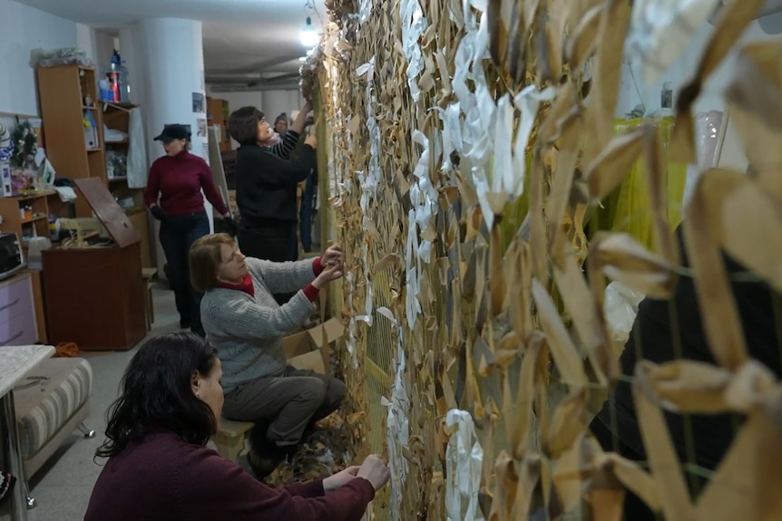 Volunteers put together camouflage netting at a small workshop in Kyiv, Ukraine.