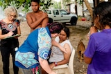 A woman gets vaccinated on the beach.