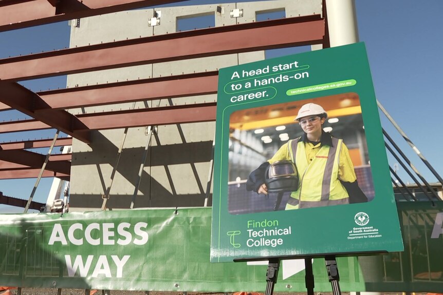 A green sign on a construction site saying 'a head start to a hands-on career'