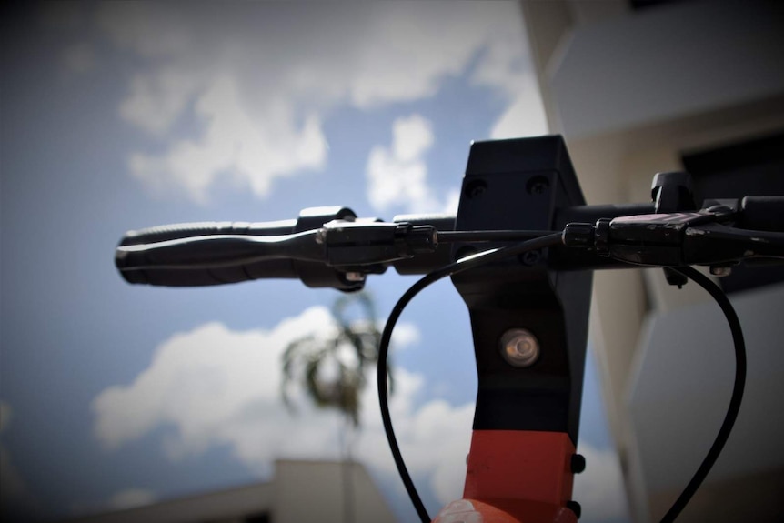 A close-up photo of the handlebars of a Neuron e-scooter in Darwin city.