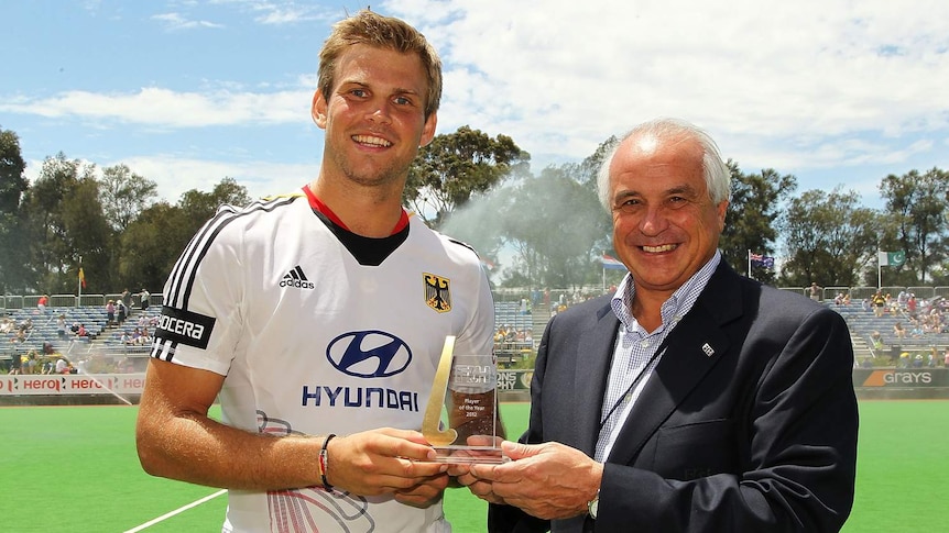 German hockey captain Moritz Fuerste (L) receives the FIH player of the year award.