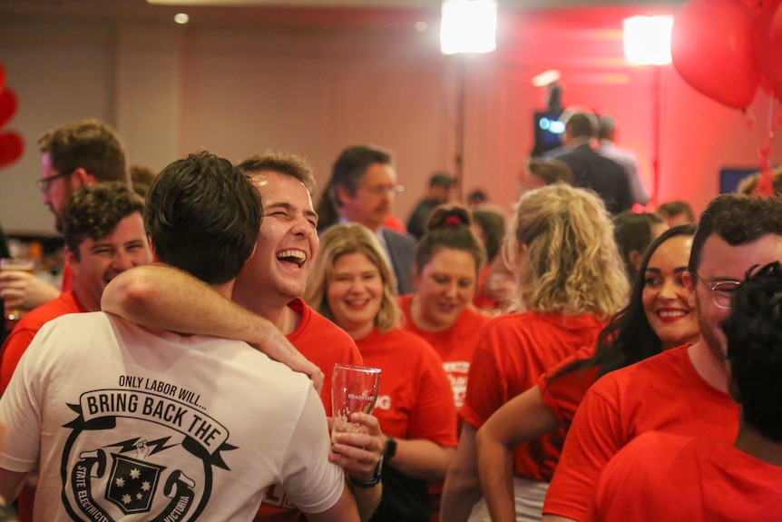 Labor members hug and celebrate.