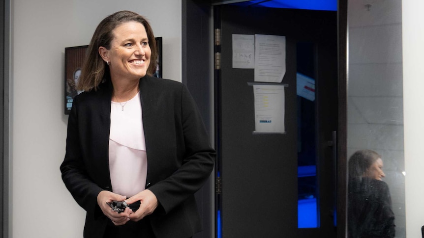 Kirstin Ferguson smiles in the newsroom