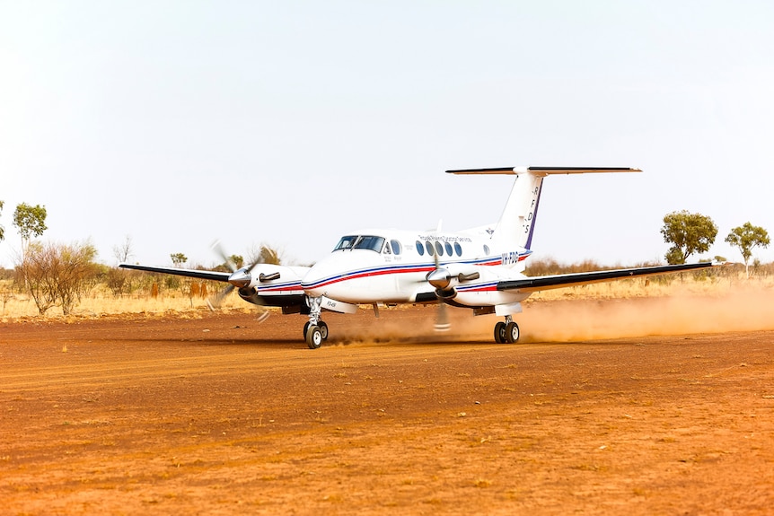 RFDS plane taking off from a gravel airstrip in regional Queensland.