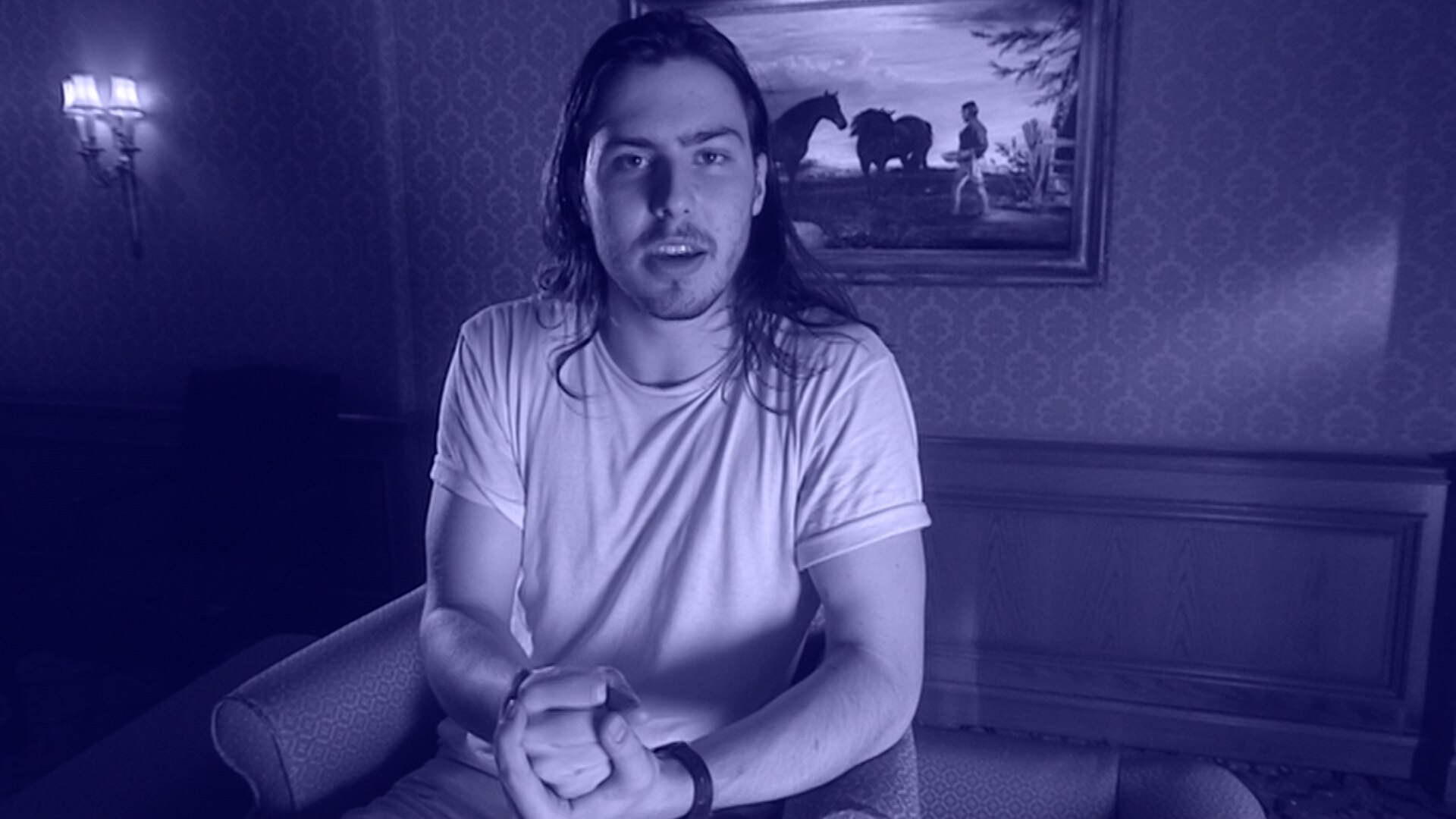 Andrew W.K. sitting on a couch in a studio