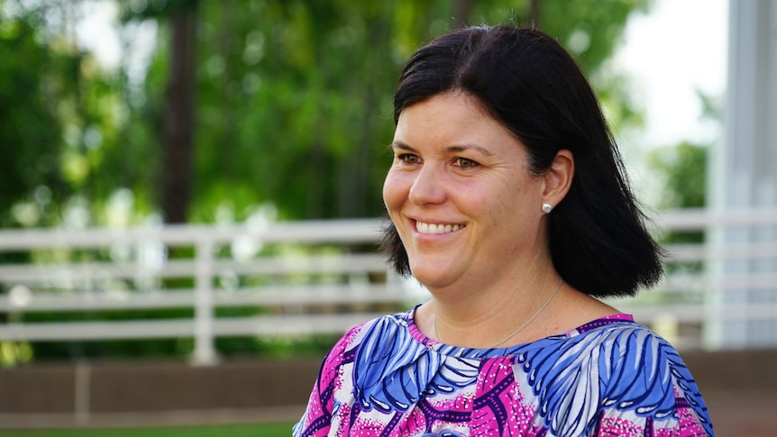 NT Health Minister Natasha Fyles stands and smiles outside NT Parliament.