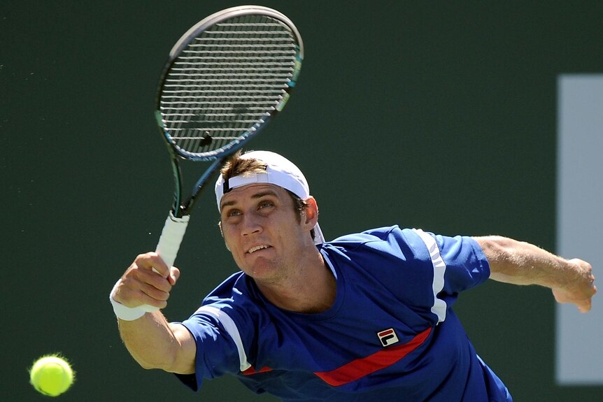 Matt Ebden stretches for a serve during his loss to John Isner.