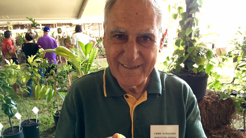 Darwin horticulturalist Chris Nathanael holds a sliced NT-grown orange