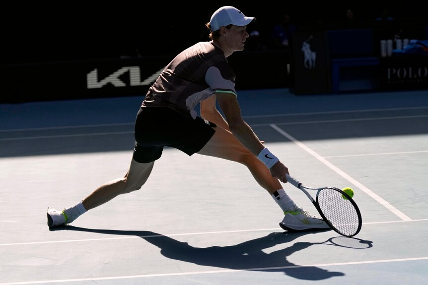 Jannik Sinner slides into a forehand at the Australian Open.