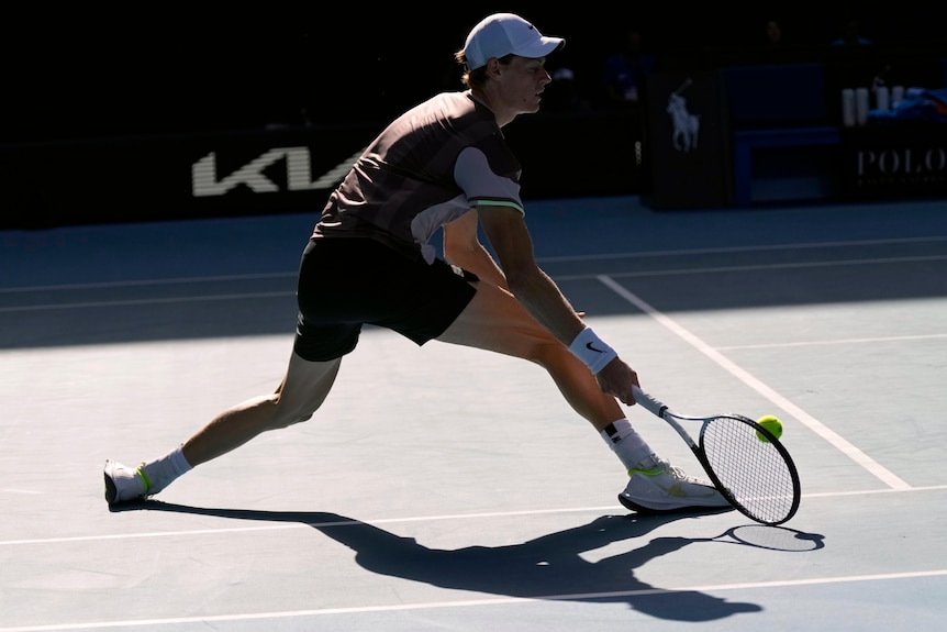 Jannik Sinner slides into a forehand at the Australian Open.