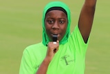 Umpire Fatoumata Toure blows a whistle, her hand in the air.